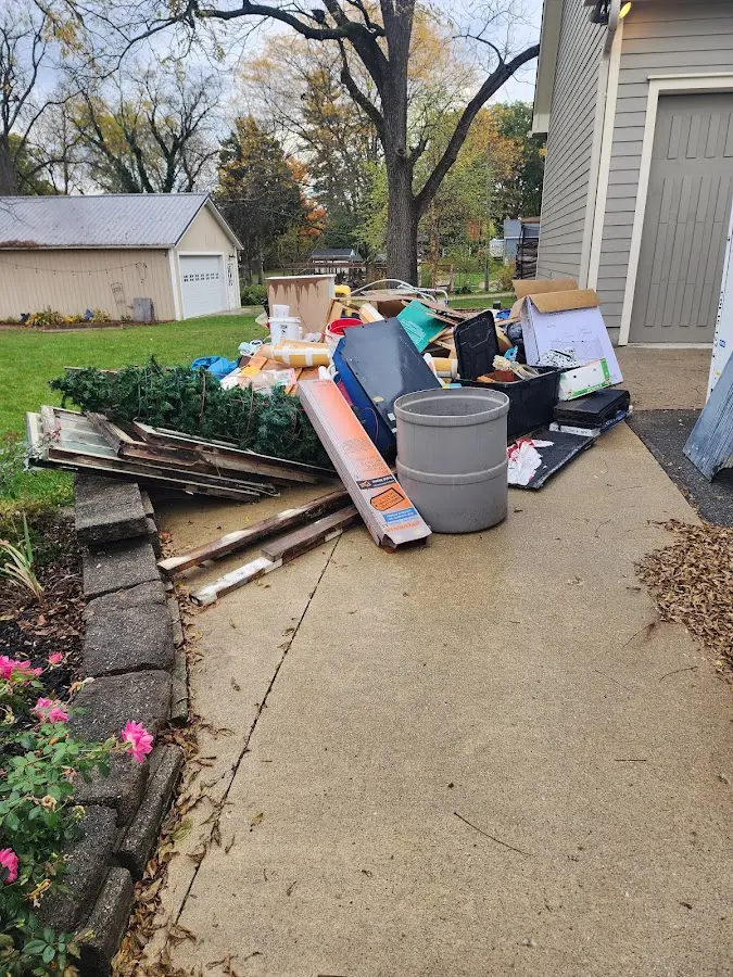 Dumpster being loaded with debris for Estate Cleanout Dumpster Rental in Nash